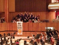 Shell Out Sounds in the Royal Festival Hall, by Hugh WarwickOn 25th October, just as a Shell-sponsored performance by the Sao Paolo Symphony Orchestra was about to start, a 15-strong choir suddenly stood up in their seats behind the stage, in full view of the audience, and began to sing.