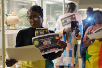 Campaigners from Senegalese civil society group Aar Li Nu Bokk speak inside the museum as part of the mass action. Photo by Amy Scaife.